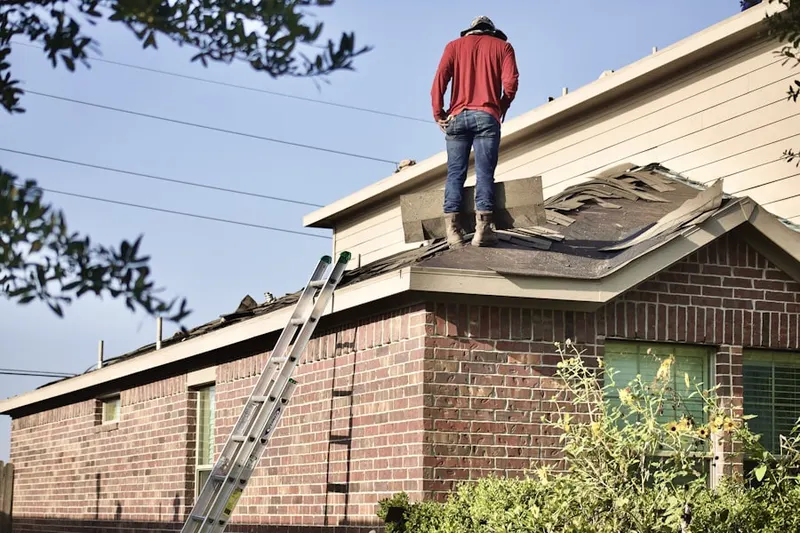 Professional roofer working on a residential roof in Mason City